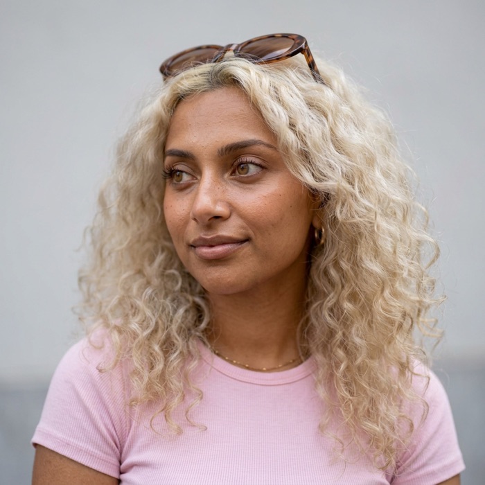 The same AI influencer looking away, thoughtful.